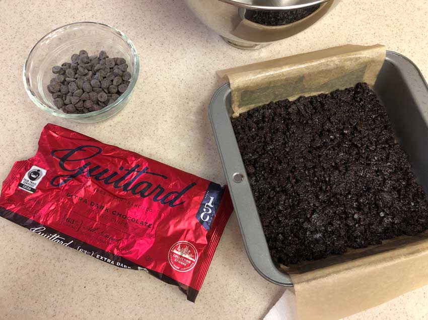 Warm brownie crust ready for the chocolate chips.